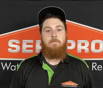 Terry Thacker in front of SERVPRO logo