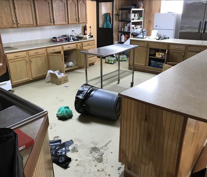 Kitchen affected by water damage before professional cleaning
